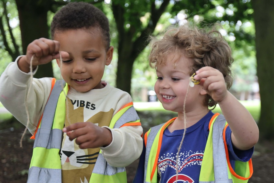 A girl climbs a tree smiling
