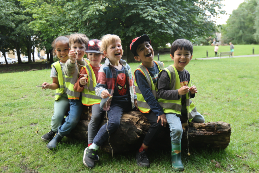 Calming Corner with a wooden arch, ivy, pillows, and a sign that says,