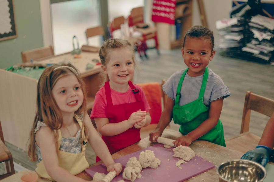 A baby is crawling down a wooden indoor climbing frame