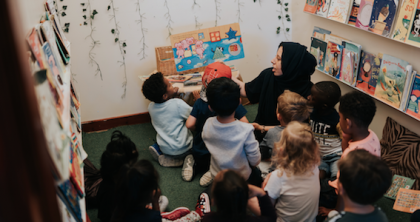 Children gathered around a member of staff ready for story time