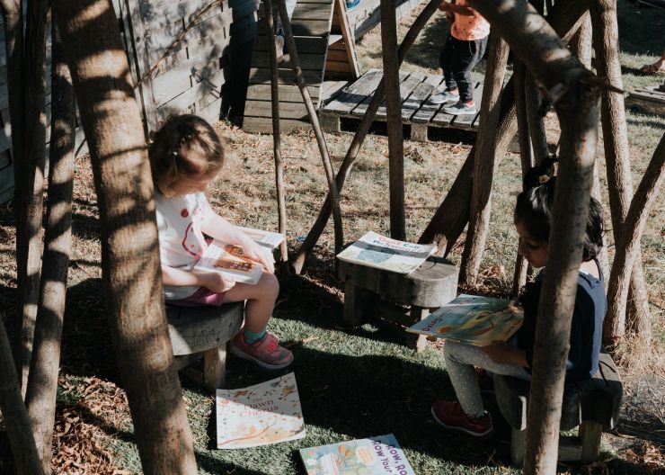 Outdoor fun - child reading in garden